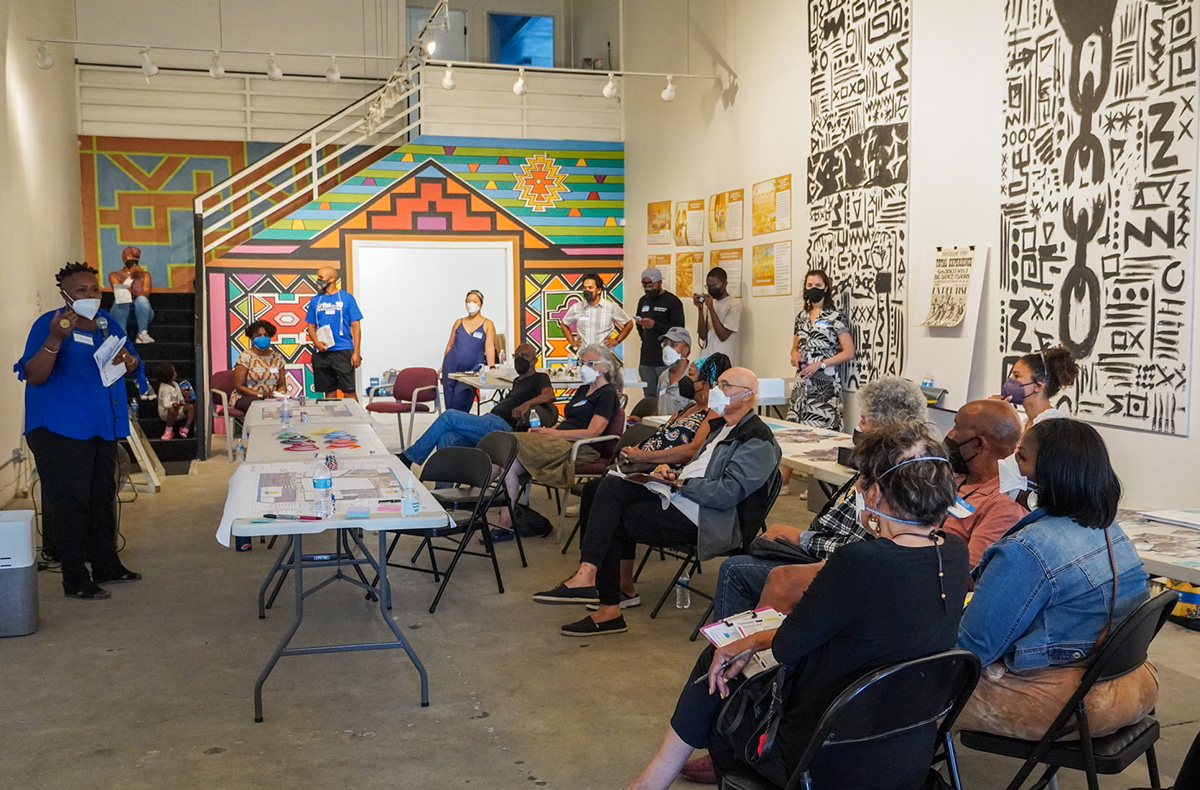 People sitting in chairs at community meeting